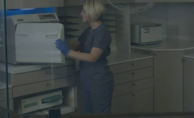 Picture of a nurse cleaning medical equipment.