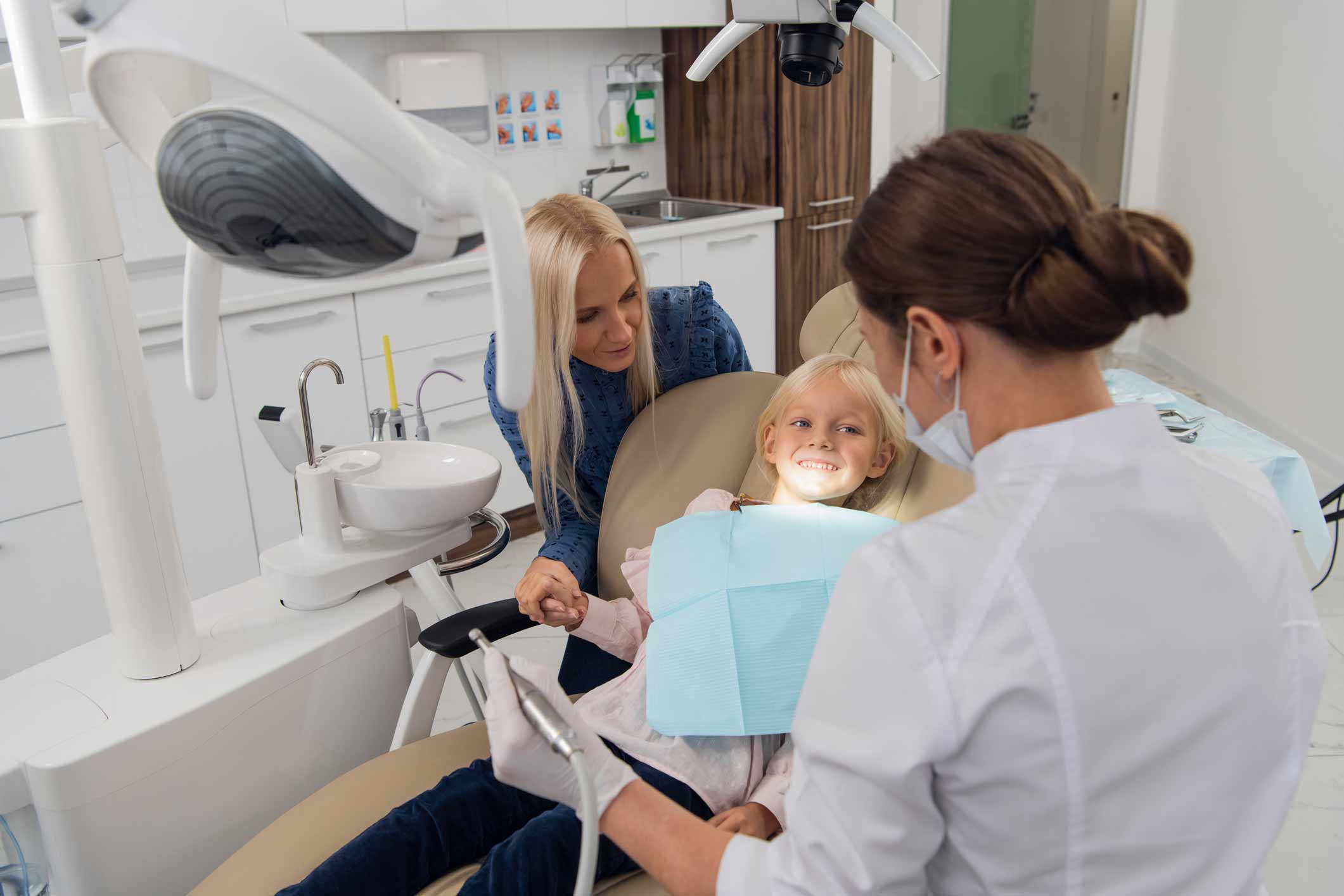 daughter and mom receiving dental treatment from a family dentist