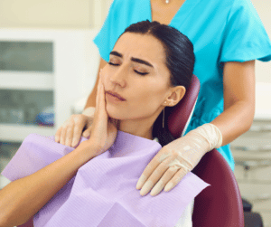 A woman in dentist chair who is suffering from TMJ